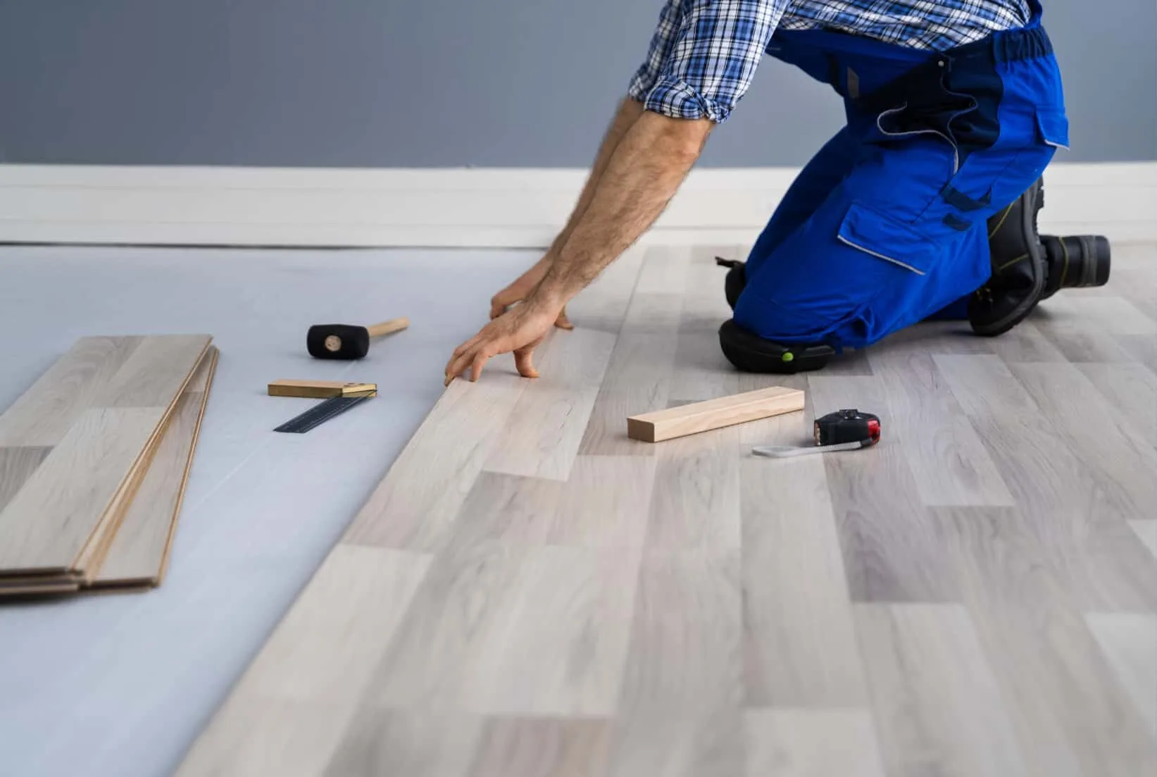 Man laying down new floor