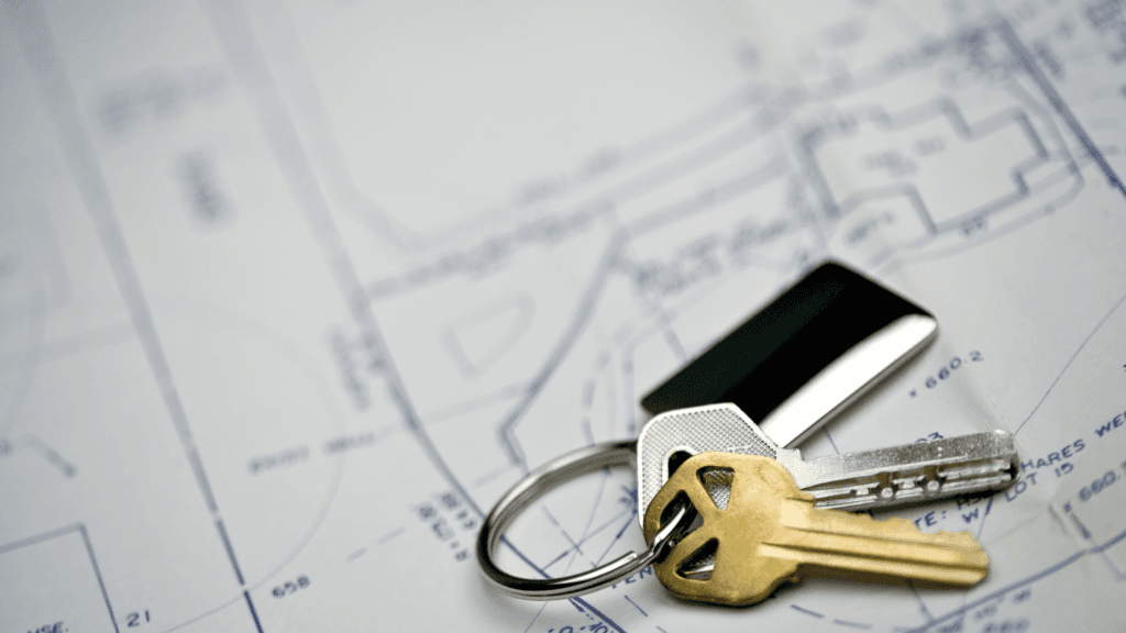 House keys resting on blueprints for a home addition plan.
