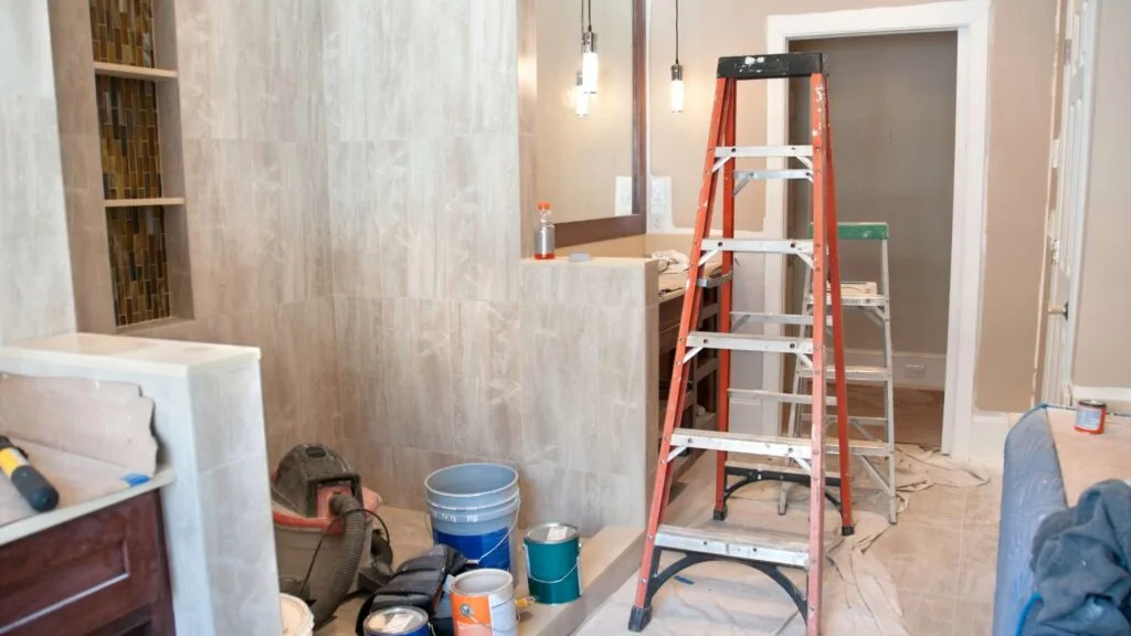 Bathroom remodeling in progress in Denver, Colorado with tools, ladder, and partially finished walls.