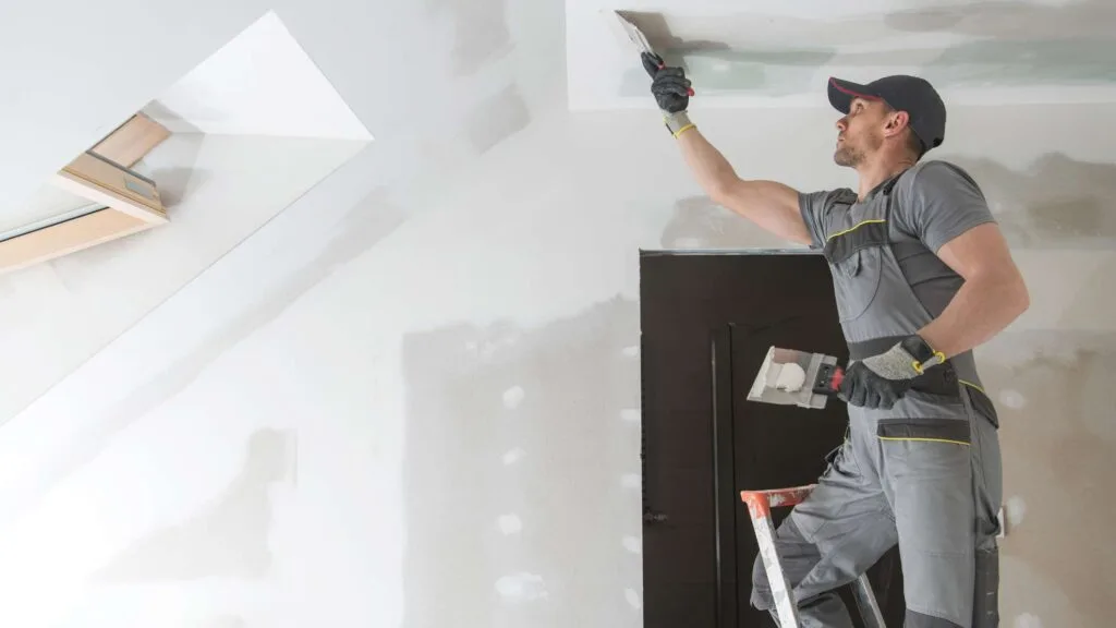 Professional painting ceiling during bathroom remodel in Denver Colorado.