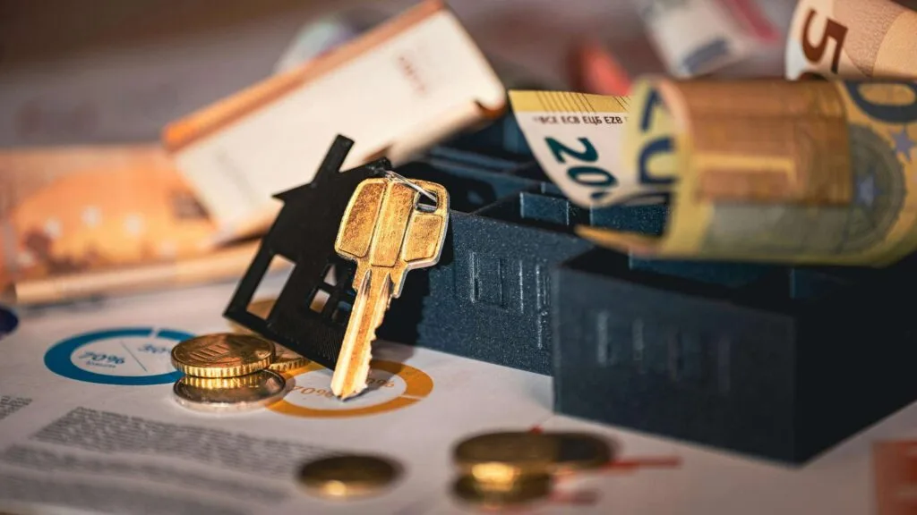 Diversified assets with coins and key representing strategic Colorado real estate investing.