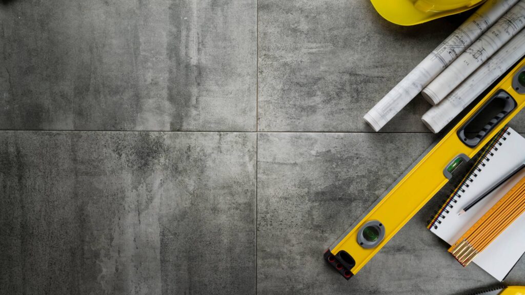 Construction tools and flooring materials laid out for a project managed by Denver General Contractors.