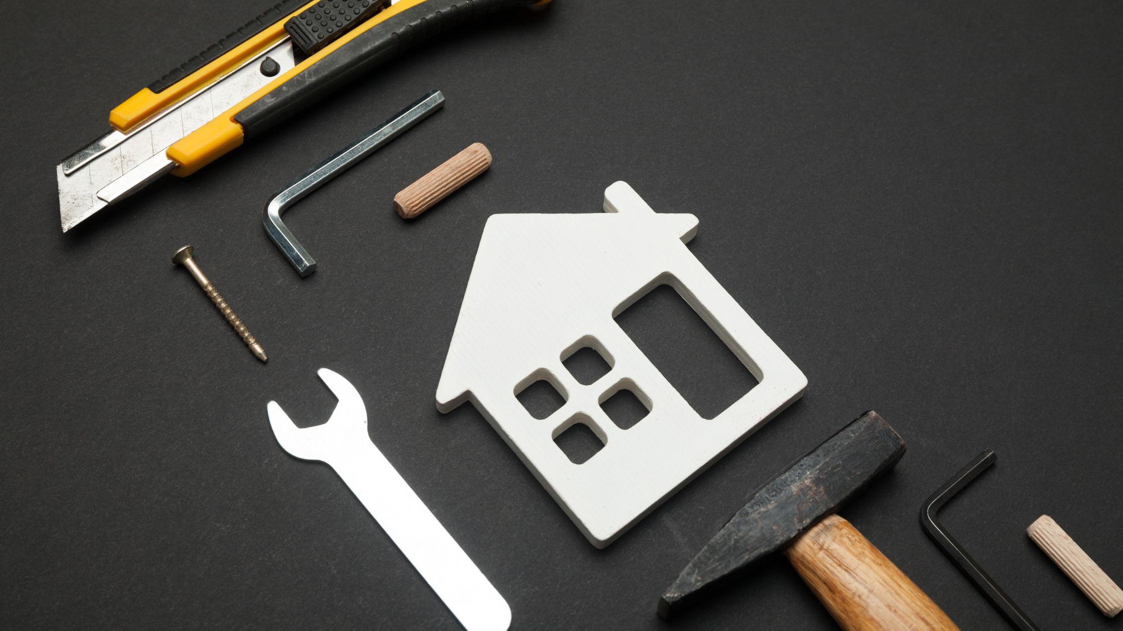 Home repair tools and house icon representing what not to fix when selling a house
