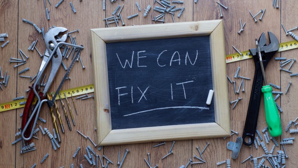 DIY tools and chalkboard message showing what not to fix when selling a house